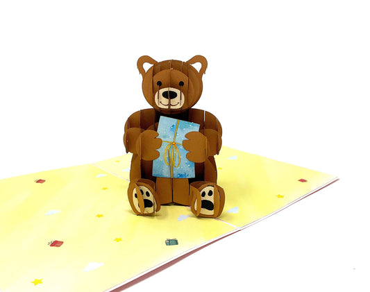 &quot;3D pop-up teddy bear greeting card with a cute bear holding a gift , perfect for sending warm wishes and affection in a unique way.&quot;