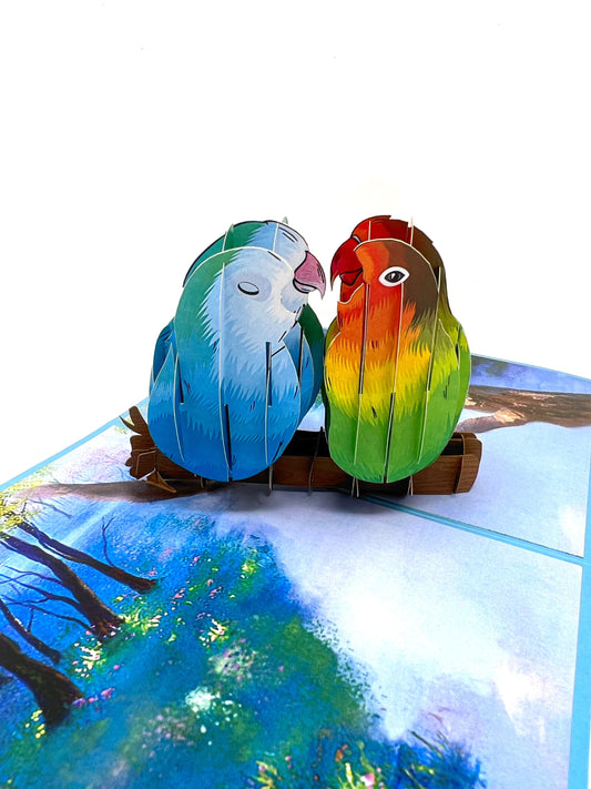 &quot;Love birds pop-up card: A three-dimensional card featuring a beautifully designed and intricately crafted pop-up of love birds, symbolizing affection and romance.&quot;
