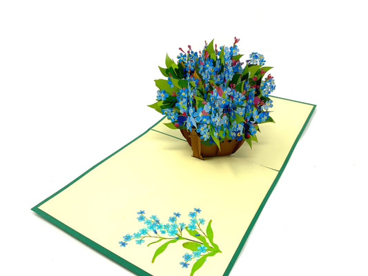 &quot;Pop-up forget-me-nots card: A three-dimensional card with a beautifully crafted pop-up display of forget-me-not flowers, evoking sentiments of remembrance and affection.&quot;
