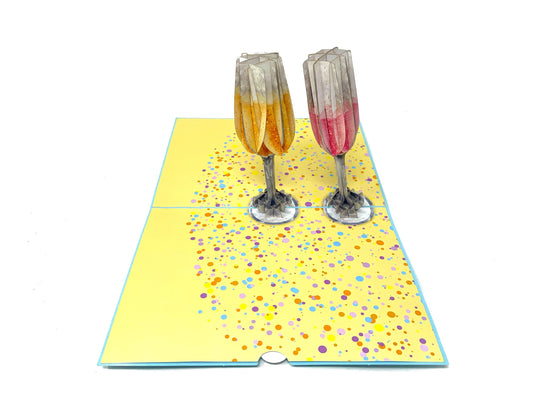 A beautifully crafted greeting card with a three-dimensional design of two champagne glasses, evoking a sense of celebration and elegance.&quot;