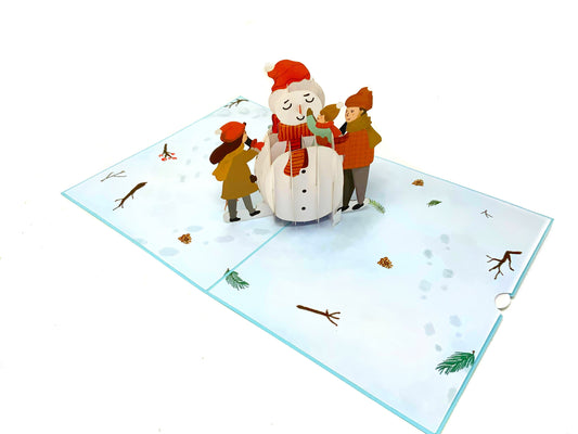 &quot;Children Building Snowman pop-up card: A three-dimensional card with an intricately crafted pop-up scene capturing the joyous moment of children building a snowman, perfect for spreading winter cheer and nostalgia on various occasions.&quot;